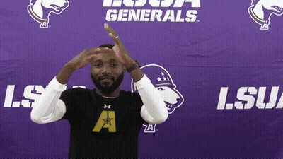 A Man Stands In Front Of A Lsu Generals Sign GIF