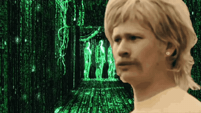 A Man Stands In Front Of A Matrix Screen GIF