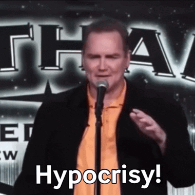 A Man Stands In Front Of A Microphone And Says Hypocrisy . GIF