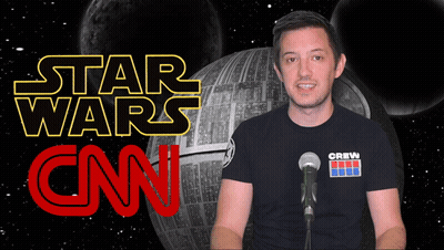 A Man Stands In Front Of A Microphone In Front Of A Star Wars Logo GIF