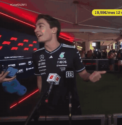 A Man Stands In Front Of A Microphone Wearing A Shirt That Says Ubs On It GIF