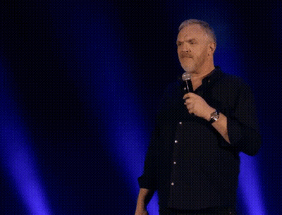 A Man Stands In Front Of A Microphone With The Words Gut Instinct Says " No " Above Him GIF
