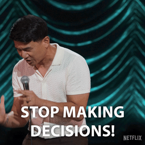 A Man Stands In Front Of A Microphone With The Words Stop Making Decisions Below Him GIF
