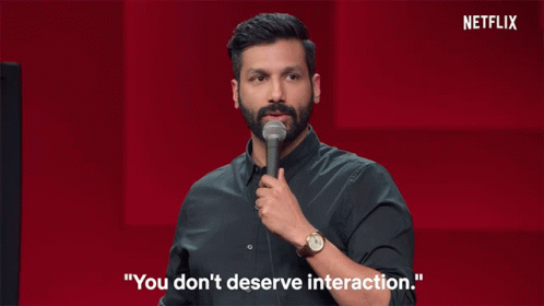 A Man Stands In Front Of A Microphone With The Words " You Don 'T Deserve Interaction " Behind Him GIF