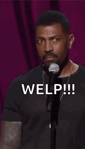 A Man Stands In Front Of A Microphone With Welp Written On The Screen GIF
