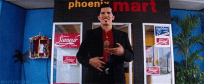 A Man Stands In Front Of A Phoenix Mart GIF