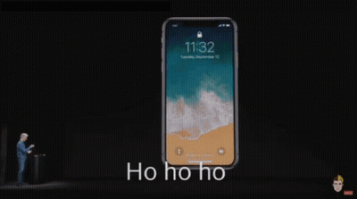 A Man Stands In Front Of A Phone That Says 11:32 On The Screen GIF