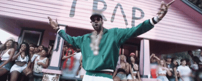 A Man Stands In Front Of A Pink Building That Says Trap On It GIF