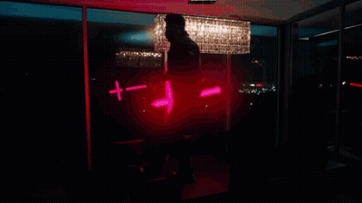 A Man Stands In Front Of A Poster That Says Madness On It GIF