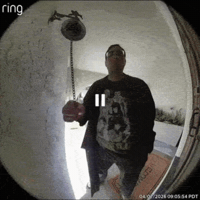 A Man Stands In Front Of A Ring Doorbell Holding A Bell GIF