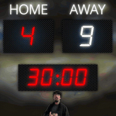 A Man Stands In Front Of A Scoreboard That Reads Home 49 Away 1:52 GIF