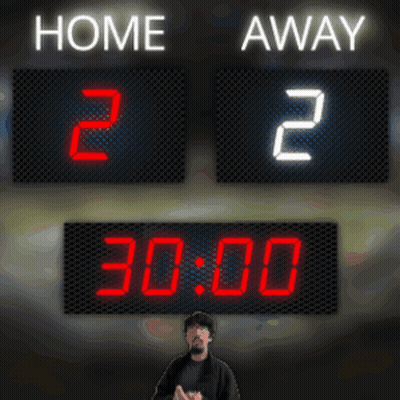 A Man Stands In Front Of A Scoreboard That Says Home 2 And Away 2 GIF