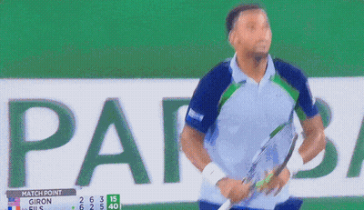 A Man Stands In Front Of A Scoreboard That Says " Match Point " GIF