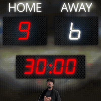 A Man Stands In Front Of A Scoreboard Which Says Home 9 Away 6 GIF