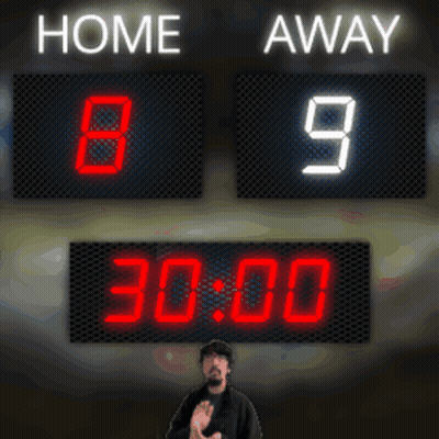 A Man Stands In Front Of A Scoreboard Which Says Home 9 Away GIF
