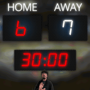 A Man Stands In Front Of A Scoreboard Which Says Home And Away GIF