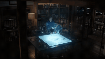 A Man Stands In Front Of A Screen That Says ' Avengers ' GIF