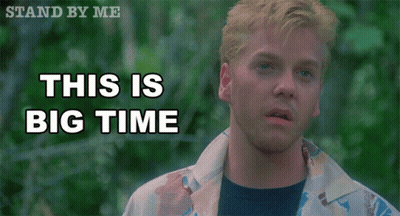 A Man Stands In Front Of A Sign That Reads This Is Big Time GIF