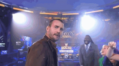 A Man Stands In Front Of A Sign That Says Backstage On It GIF