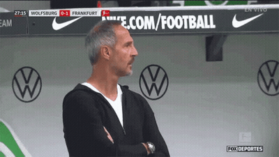 A Man Stands In Front Of A Sign That Says Ecom/football GIF