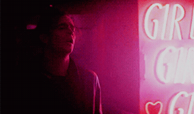 A Man Stands In Front Of A Sign That Says Girl GIF