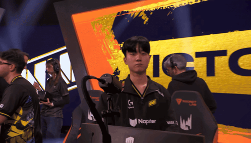 A Man Stands In Front Of A Sign That Says Ictc On It GIF