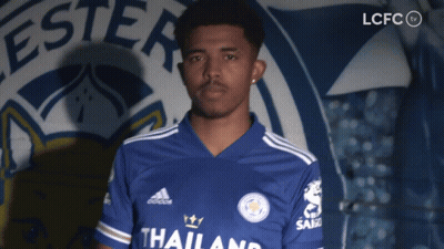 A Man Stands In Front Of A Sign That Says Lcfc On It GIF