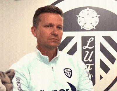 A Man Stands In Front Of A Sign That Says ' Lu ' On It GIF