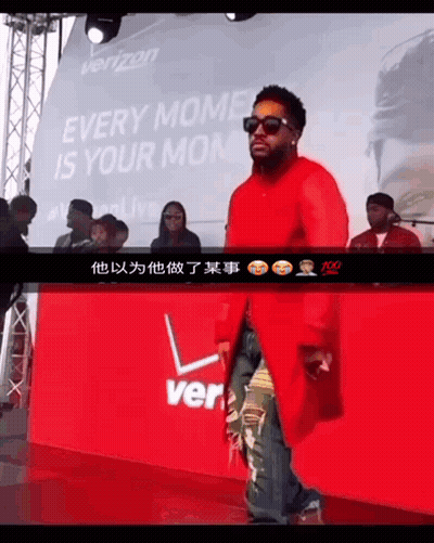 A Man Stands In Front Of A Sign That Says Verizon GIF