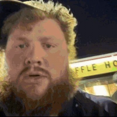 A Man Stands In Front Of A Sign That Says Waffle House GIF