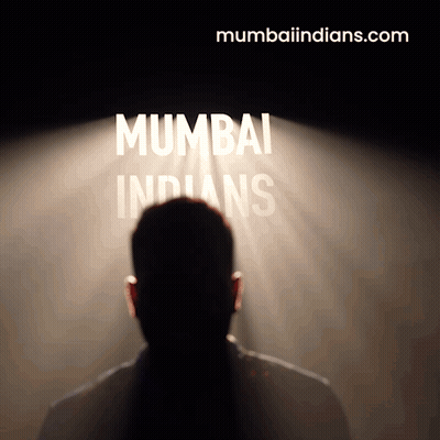 A Man Stands In Front Of A Spotlight That Says Mumbai Indians GIF