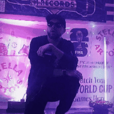 A Man Stands In Front Of A Stella Records Sign GIF