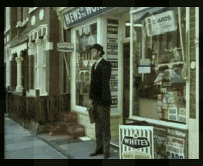 A Man Stands In Front Of A Store That Sells Whites Cigarettes GIF