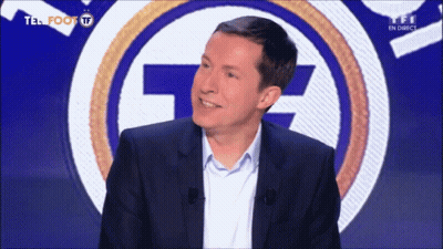 A Man Stands In Front Of A Tf Logo GIF