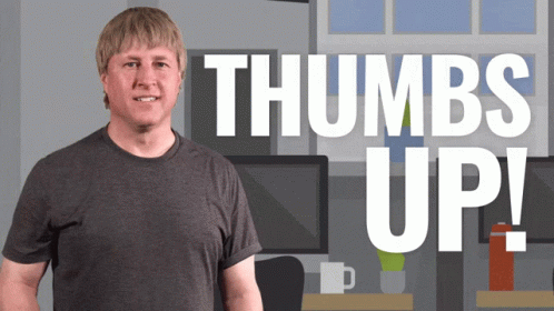 A Man Stands In Front Of A Thumbs Up Sign GIF