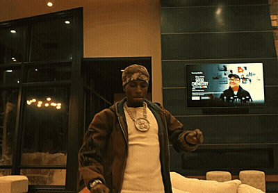 A Man Stands In Front Of A TV Screen That Says ' A Few Dollars ' On It GIF