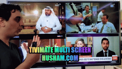 A Man Stands In Front Of A Tv Screen That Says Tivimate Multi Screen Husham.com On It GIF