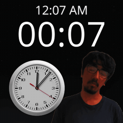 A Man Stands In Front Of A Wall Clock That Says 12:07 Am GIF