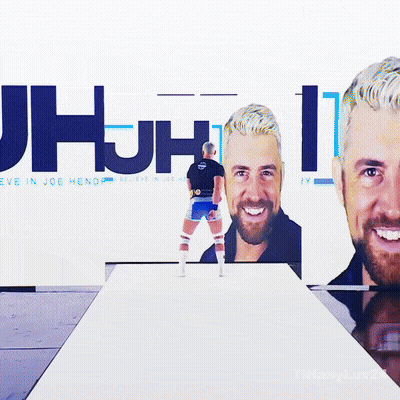 A Man Stands In Front Of A Wall That Says Jhjh GIF