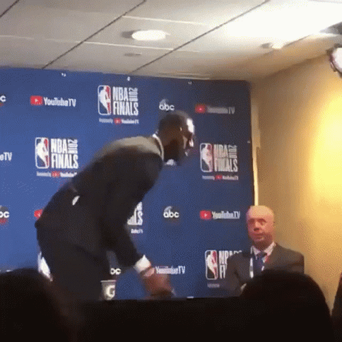 Man In Front Of NBA Finals Wall GIF