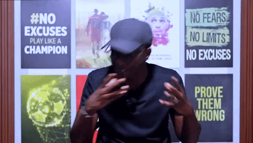 A Man Stands In Front Of A Wall That Says #No Excuses GIF