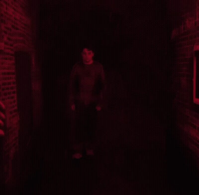 A Man Stands In Front Of A Wall That Says Unmask The Truth On It GIF
