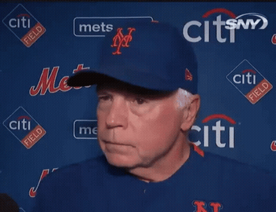 A Man Stands In Front Of A Wall With Citi Field Logos GIF