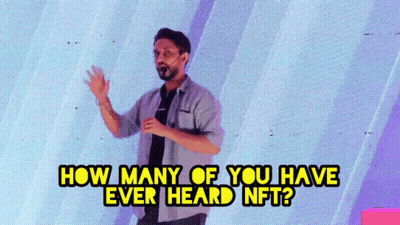 A Man Stands In Front Of A Wall With The Words " How Many Of You Have Ever Heard Nft " Above Him GIF