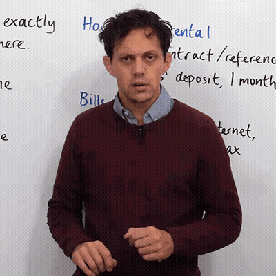 A Man Stands In Front Of A White Board With The Words Exactly Written On It GIF