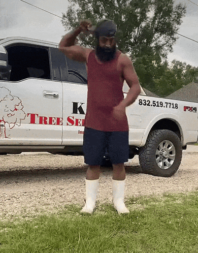 A Man Stands In Front Of A White Truck That Says K Tree Service GIF