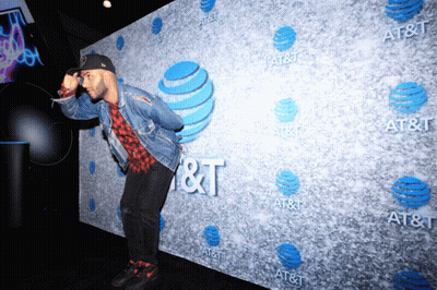 A Man Stands In Front Of An At & T Sign GIF