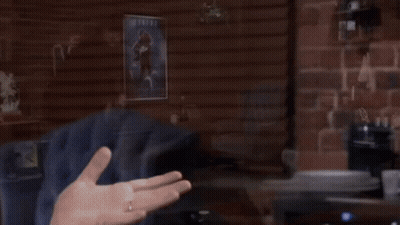 A Man Stands In Front Of An Atari Machine In A Room GIF