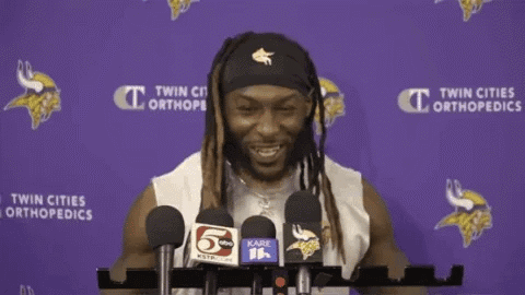 A Man Stands In Front Of Microphones With His Arms Outstretched GIF