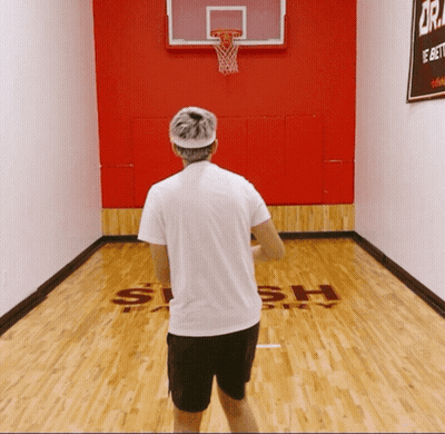 A Man Stands On A Basketball Court That Says Slash GIF